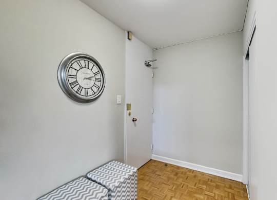 a living room with a clock on the wall and a couch