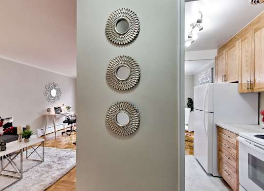 a view of a kitchen and living room from behind a door