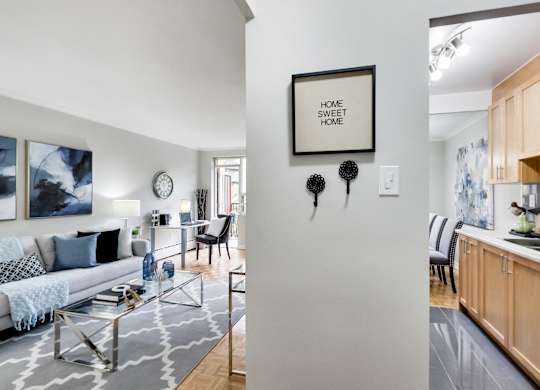 a living room and kitchen with a couch and a table
