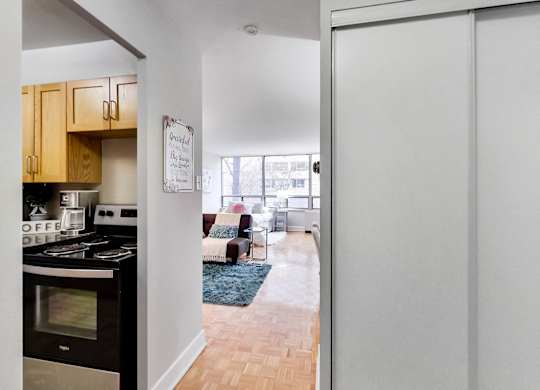 A kitchen with a stove top oven and a white door.