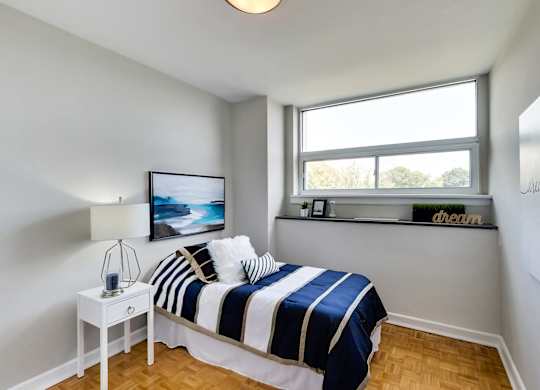 a bedroom with a bed and a window