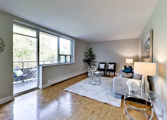 an open living room with a couch and a glass coffee table