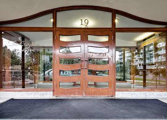 The front door of a building with the number 19 on it.