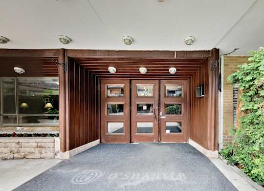 the entrance to a building with wooden doors