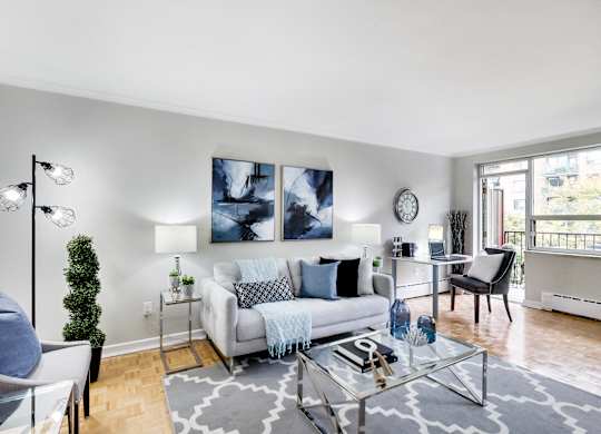 a living room with a couch and a glass table