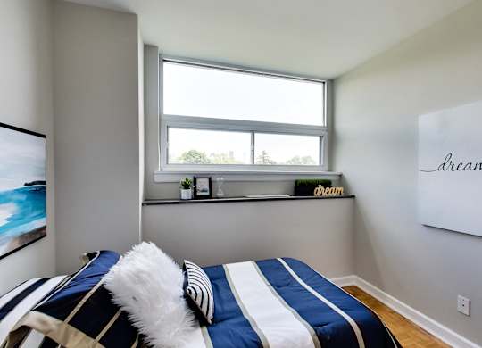 a bedroom with a bed and a window
