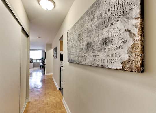 A hallway with a large piece of artwork on the wall.