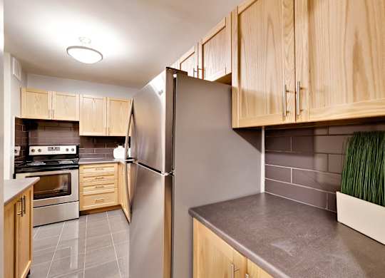 a kitchen with stainless steel appliances and wooden cabinets