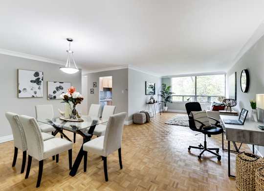 A dining room with a glass table and chairs.