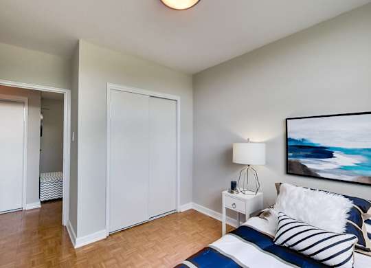 a bedroom with a bed and a mirror and a closet