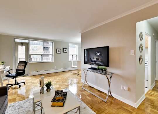 a living room with a tv and a table with a chair