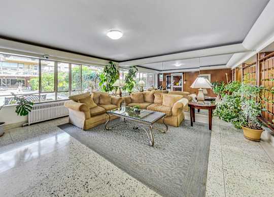 a living room with couches and a table     and a large