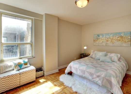 a bedroom with a bed and a window