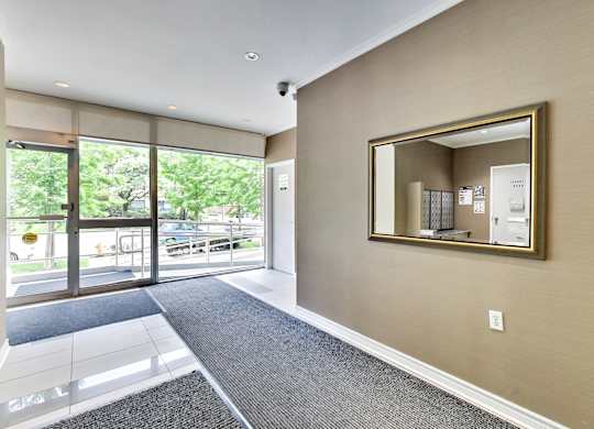 a large mirror in the center of a room next to a door