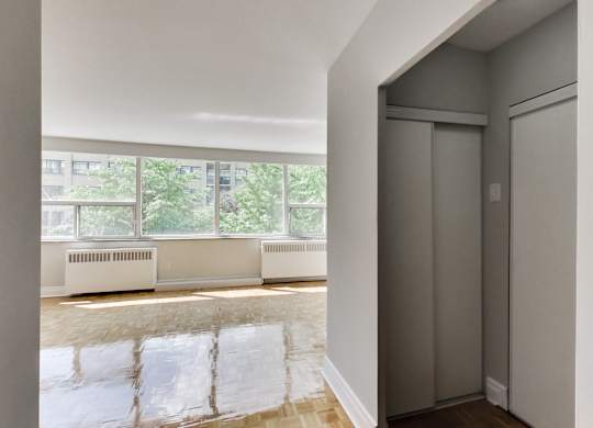a living room with a large window and a door