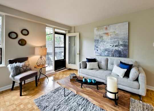 a living room with a couch and a chair and a table