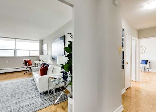 a living room with a white couch and a glass table