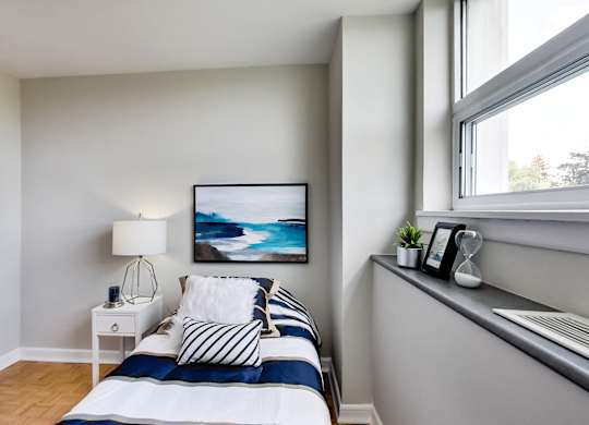 a small bedroom with a bed and a window