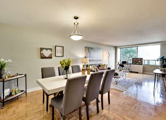A dining room with a table and chairs.