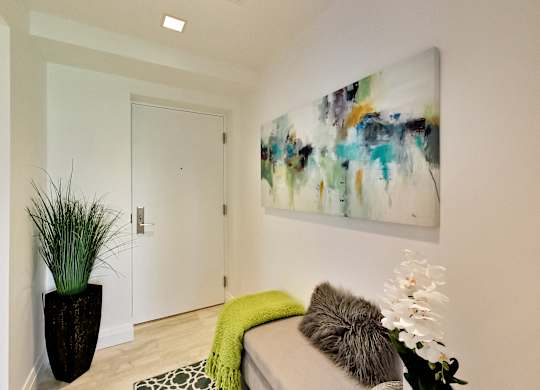 a living room with a couch and a painting on the wall