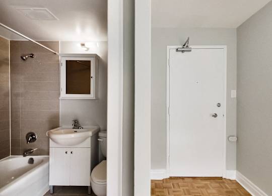 a bathroom with a sink toilet and shower and a mirror