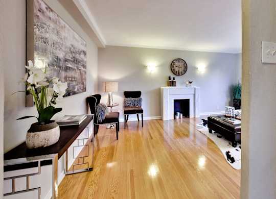 a living room with a fireplace and a large painting on the wall