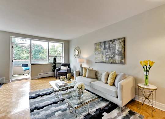 a living room with a white couch and a glass coffee table