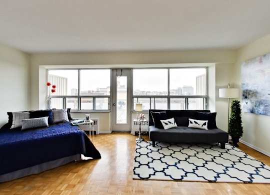 A bedroom with a large bed and a couch.