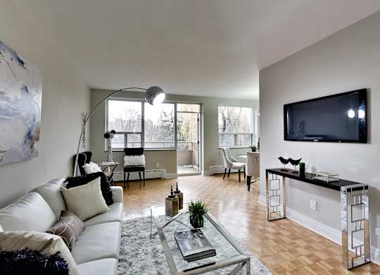 an open living room with a couch and a tv
