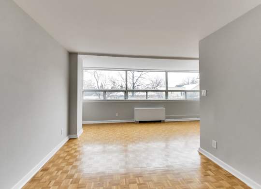 an empty living room with a large window