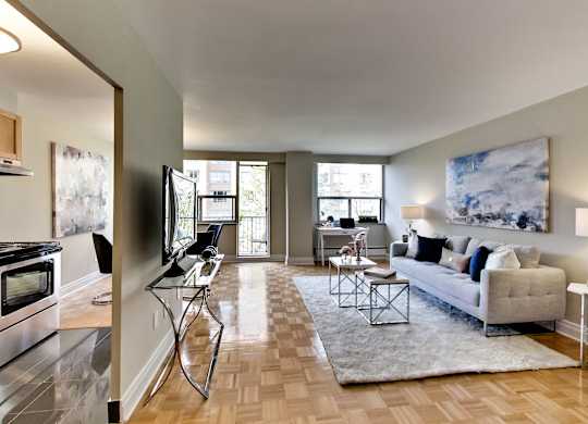 a living room with a couch and a chair and a tv