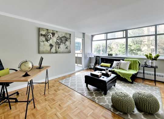 A living room with a green couch and a wooden table.