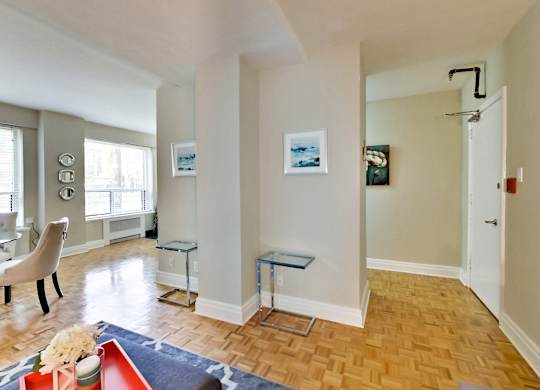 a living room with a hard wood floor and white walls