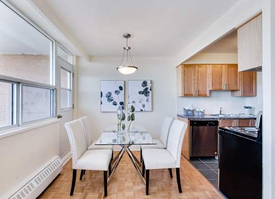 A kitchen with a table and chairs in the middle of the room.