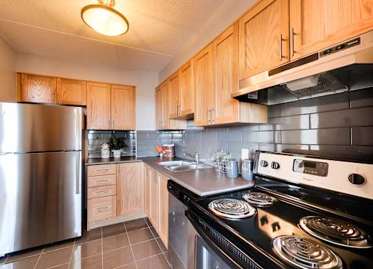 a kitchen with stainless steel appliances and wooden cabinets
