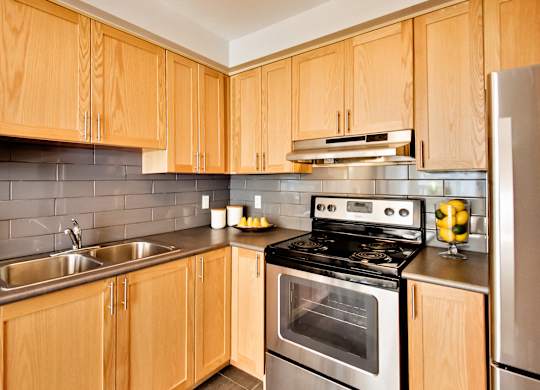 a kitchen with stainless steel appliances and wooden cabinets