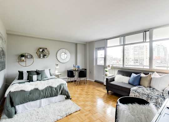 A bedroom with a large bed and a couch.