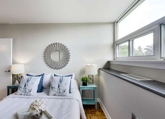 a bedroom with a large bed and a window