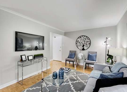 a living room with a couch and a glass coffee table