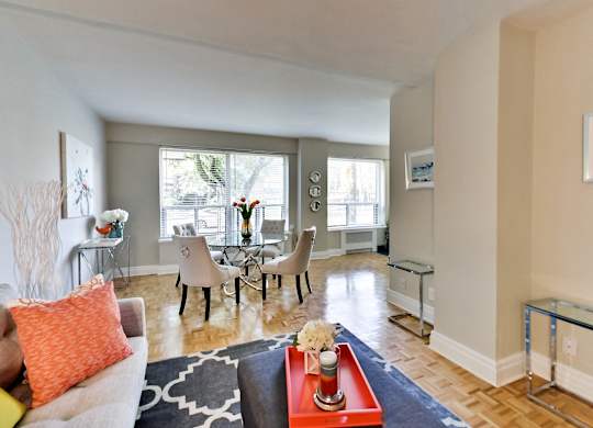 a living room with a couch and a table with chairs