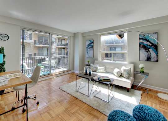 a living room with a couch and a table and a balcony