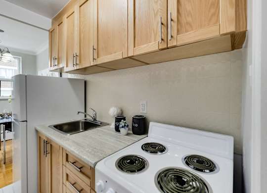 a kitchen with white appliances and wood cabinets