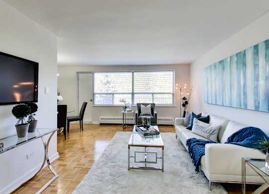a living room with a couch and a coffee table and a television