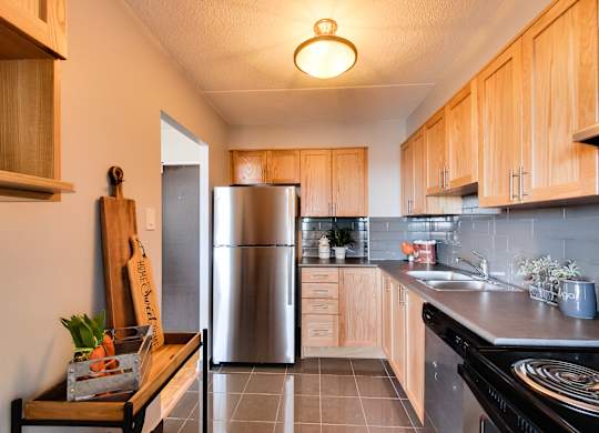 a kitchen with stainless steel appliances and wooden cabinets