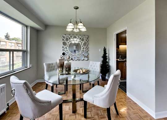 an image of a dining room with a glass table and chairs