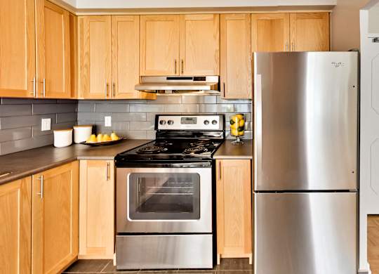 a kitchen with stainless steel appliances and wooden cabinets