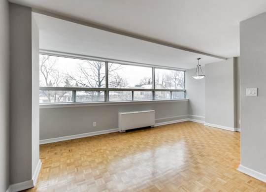 an empty living room with a large window