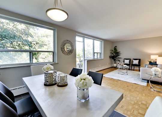 a dining room with a table and chairs and a living room