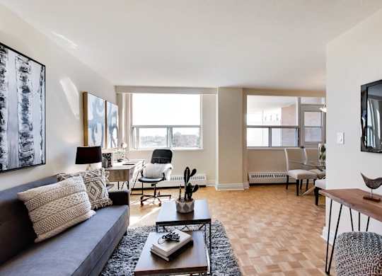 A living room with a brown couch, a coffee table, and a television.