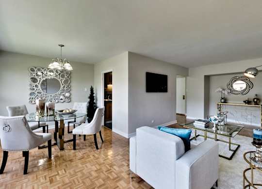 a living room and dining room with a glass table and chairs